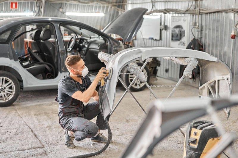 Technician repairing a vehicle body panel